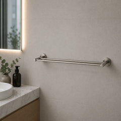 Bathroom setting with a towel rail on a tiled wall, sink, and decorative elements.