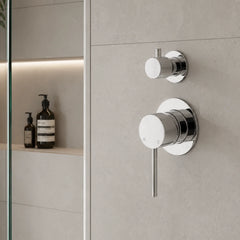 Chrome shower control panel on a tiled bathroom wall.