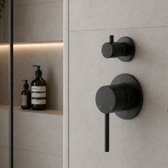 Black shower control panel on a tiled wall