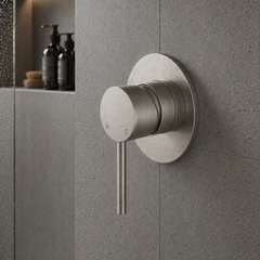 Modern shower control valve on a gray tiled wall