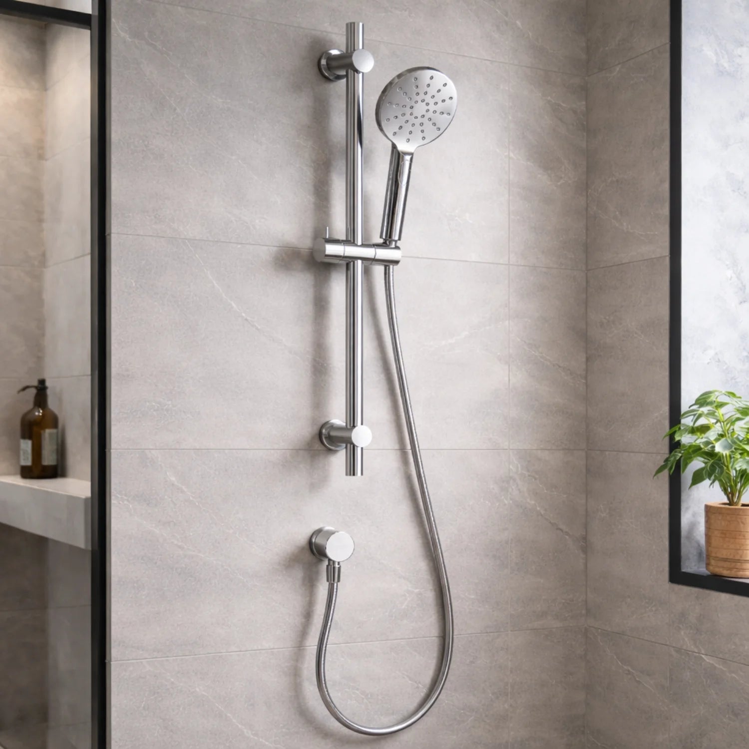 Chrome shower system mounted on a tiled bathroom wall.