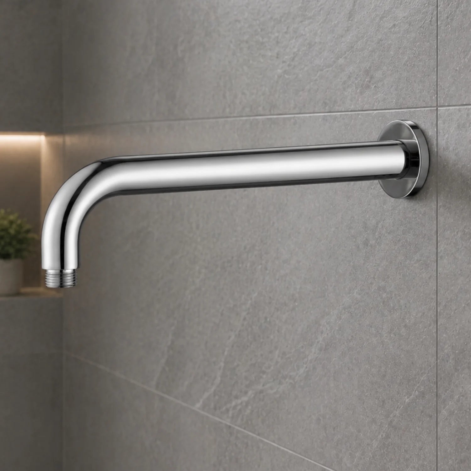 Chrome shower arm mounted on a gray tiled wall