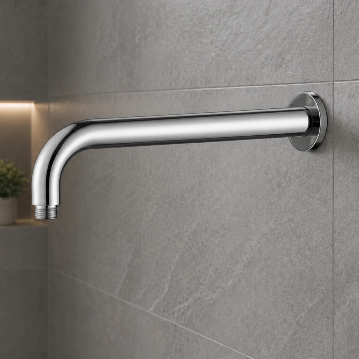 Chrome shower arm mounted on a gray tiled wall