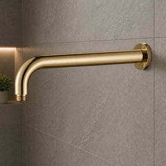 French Gold shower arm mounted on a gray tiled wall